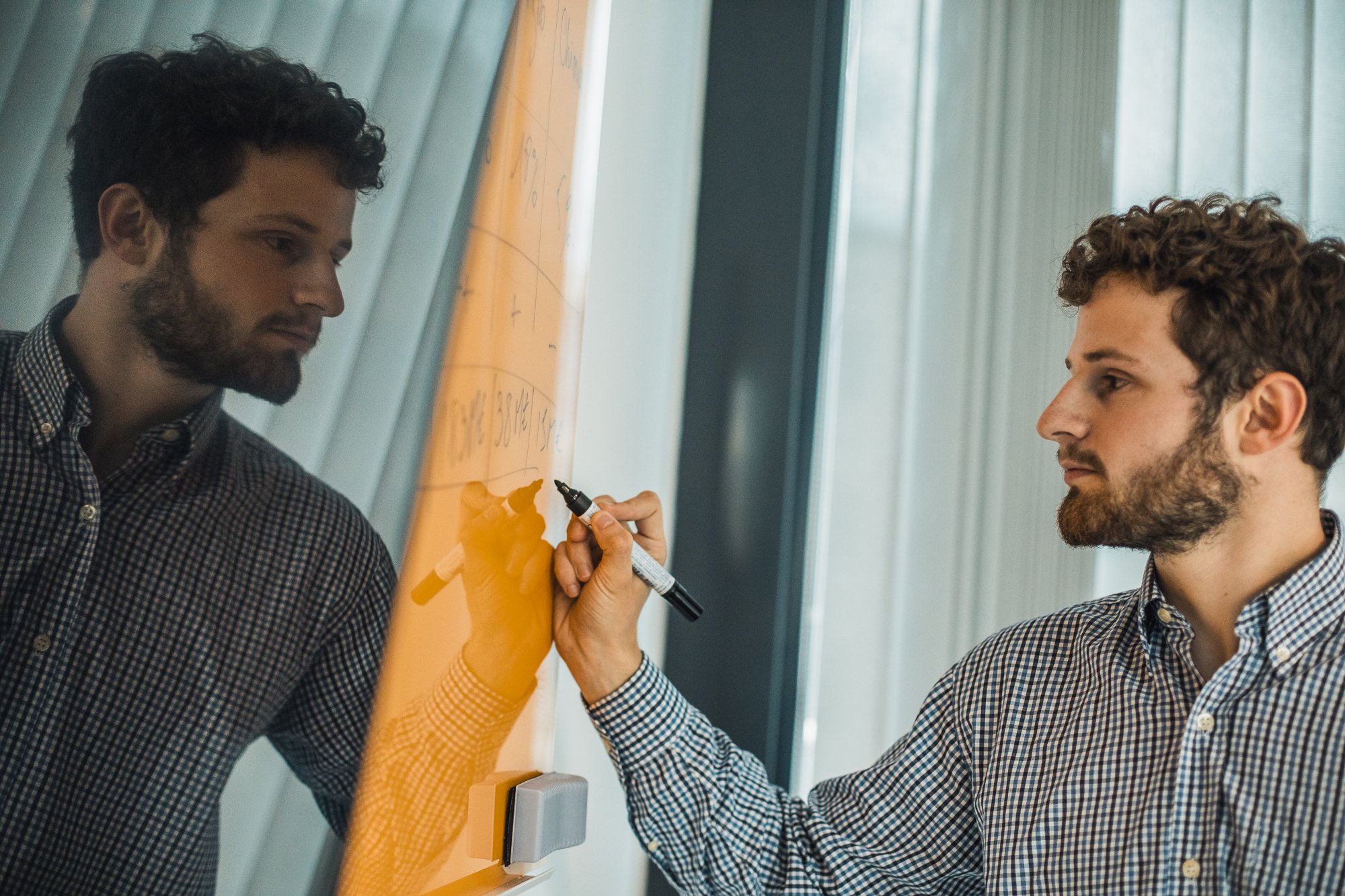 Atradius Colleague working on a board in the Paris Office-1 Atradius Colleague working on a board in the Paris Office-1