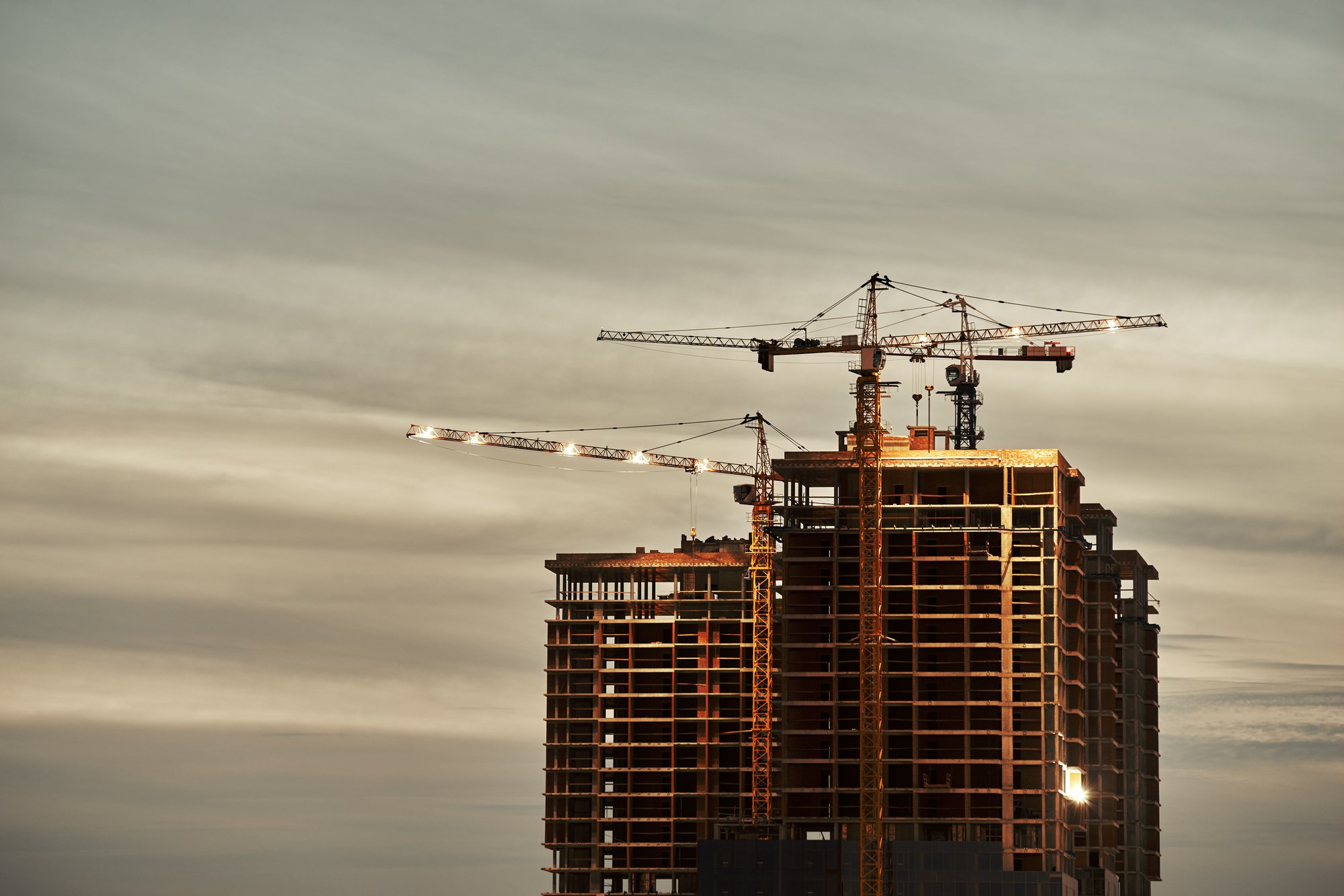 Construction site with crane at dusk Construction site with crane at dusk