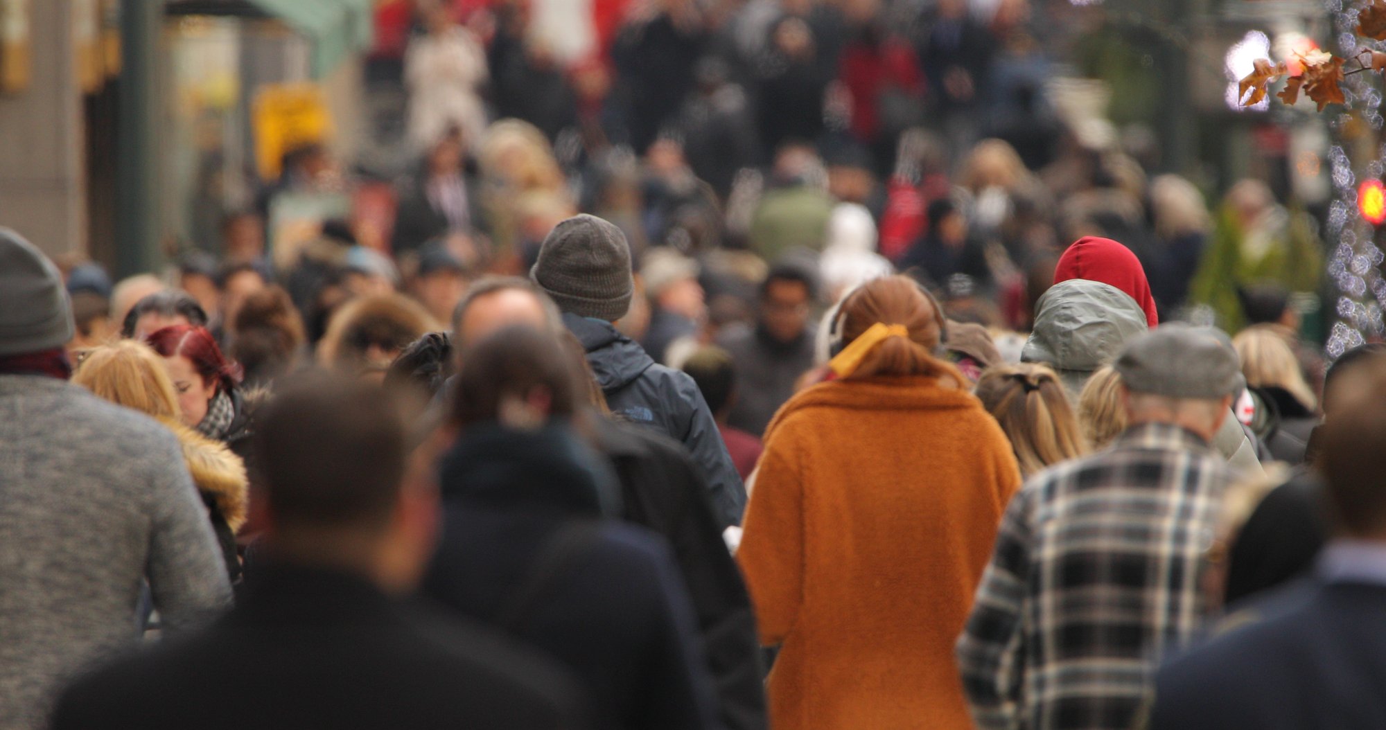 Crowd of people walking down a busy street Crowd of people walking down a busy street