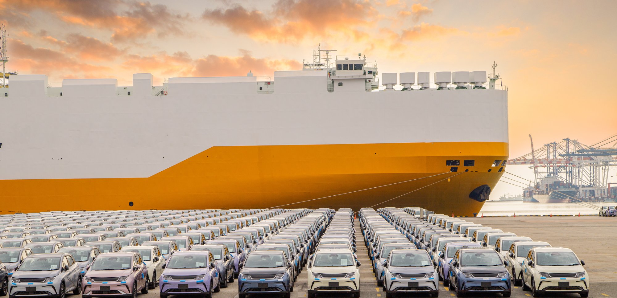 new cars parked in front of a ship in the harbour new cars parked in front of a ship in the harbour