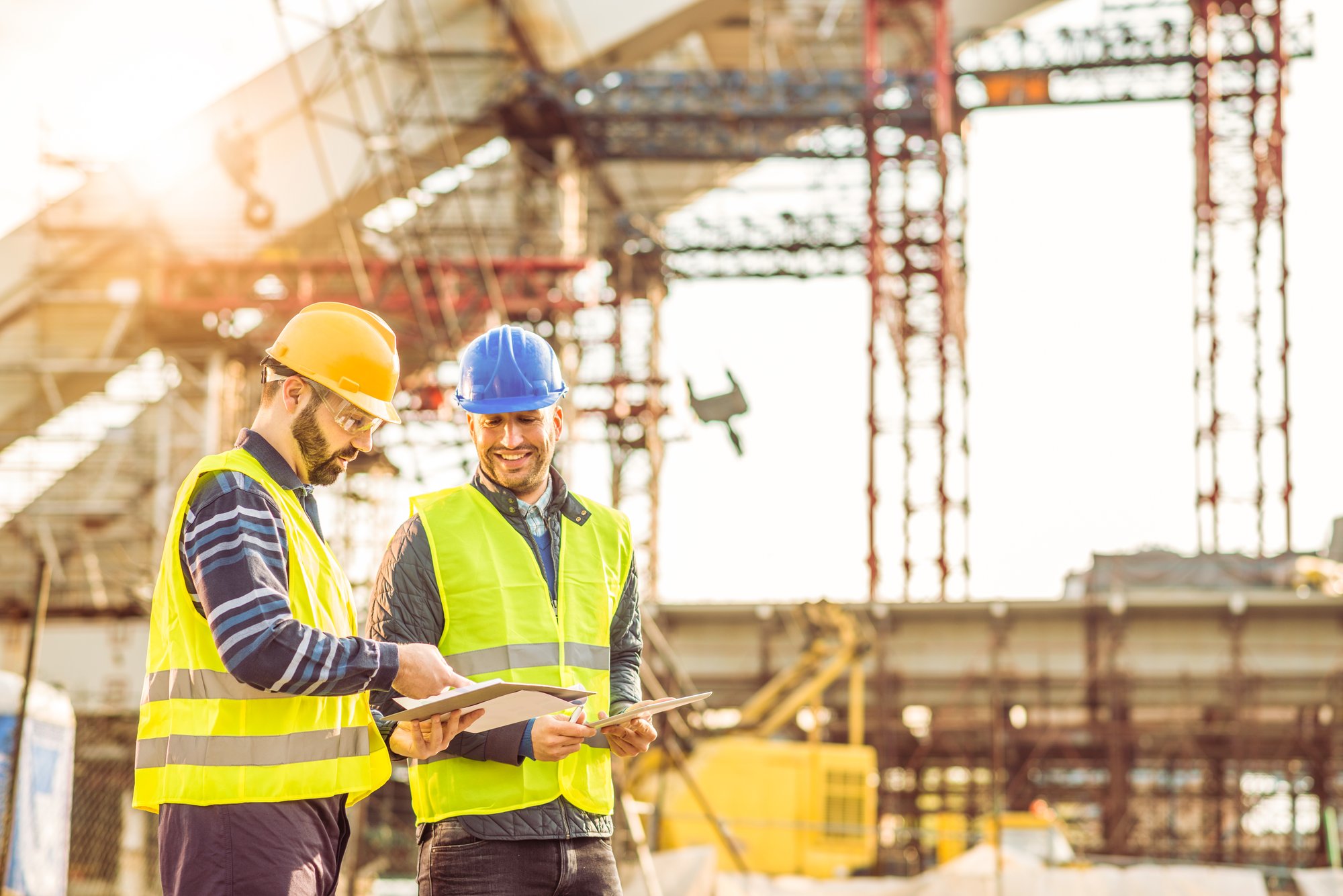 two construction workers conducting a survey
