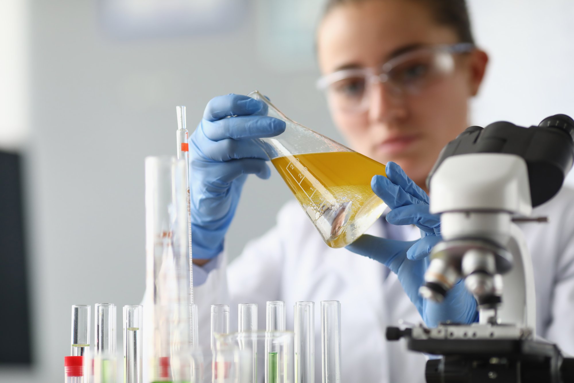 woman chemist scientist holding flask at hand (1)